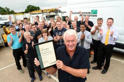 •	John Kington is congratulated for his 50 years’ service by his team-mates.