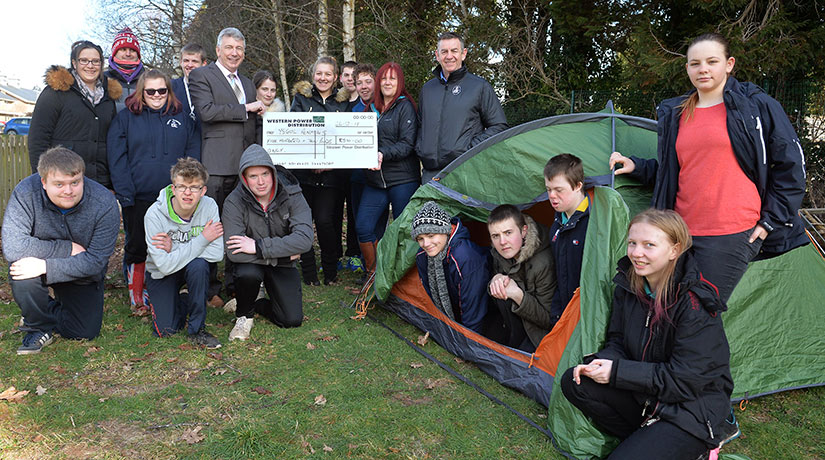 Students from Powys county in the U.K pose with a check from WPD, intended to help students participate in the DofE program