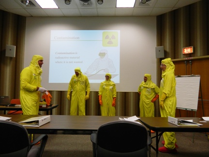 Students dress in the protective clothing used when working in certain areas of the plant as part of the instruction about PPL’s radiation and safety practices.
